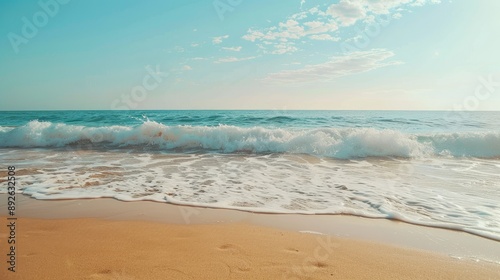 Beach with gentle waves, golden sand, and clear sky, perfect for vacation ads