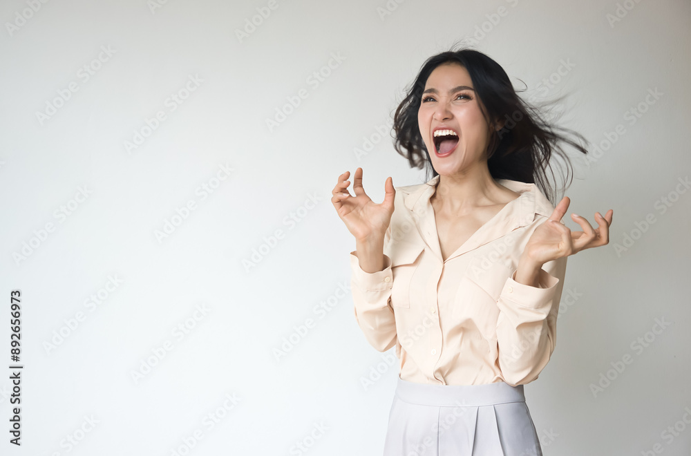 Angry upset unhappy young adult Asian woman with very angry emotion, screaming or shouting out loud Angry upset unhappy young adult Asian woman with very angry emotion, screaming or shouting out loud