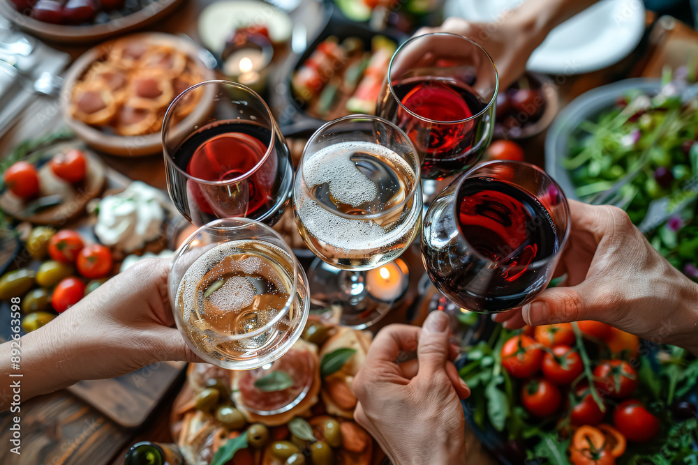 A group of people are holding up wine glasses in a celebratory manner ...