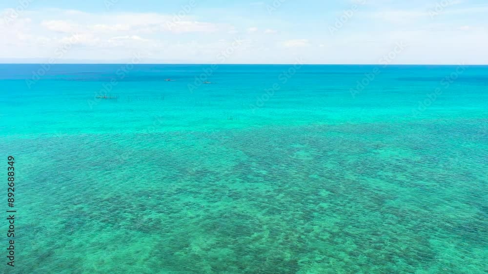Sea surface with clear turquoise waters. Tropical coral reefs under blue sky and clouds. Cebu, Philippines. Sea surface with clear turquoise waters. Tropical coral reefs under blue sky and clouds. Cebu, Philippines.