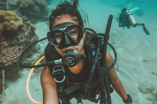 Wallpaper Mural A scuba diver, wearing a full diving suit, is underwater, exploring a coral reef Torontodigital.ca