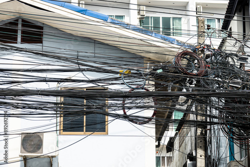 Photography A house with a lot of wires hanging from the roof
