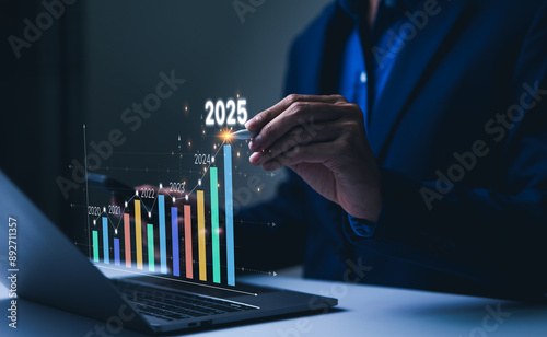 The 2025 New Year business goals concept. Businessman analyzes graph of trend market growth in 2025 and plans business growth and profit increases. calculates financial data for long-term investments.