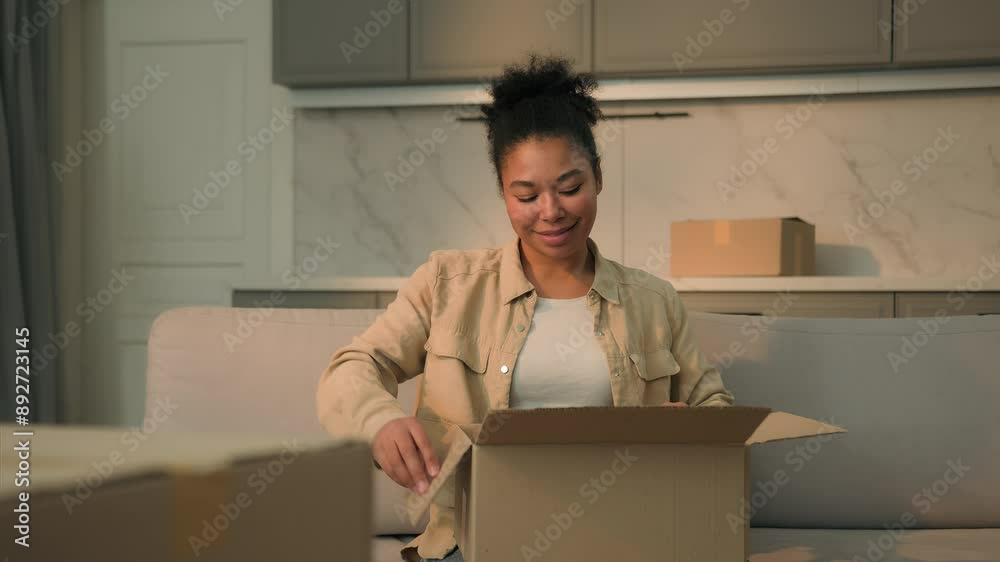 Happy African american woman open cardboard express delivery female girl homeowner tenant housewife unpacking box unpack parcel clothes goods online shopping moving new home relocation mortgage loan