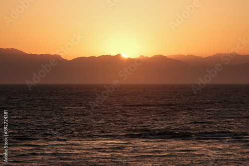 Sunrise view of Gulf of Aqaba of Red Sea and mountains of Saudi Arabia. View from Dahab, Egypt.