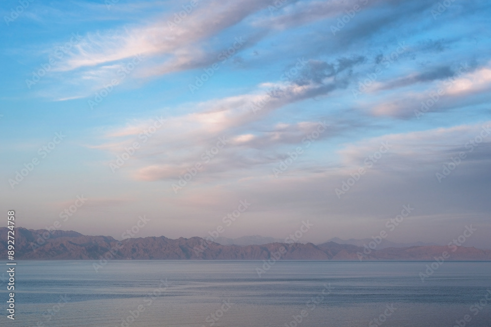Fototapeta premium Sunset clouds above Gulf of Aqaba of Red Sea. View from Dahab, Egypt.
