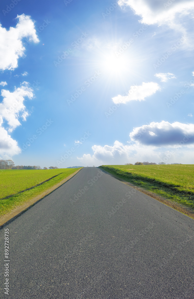 Road, countryside and outdoor path for travel, vacation or holiday with clouds in summer sky. Street, highway and asphalt in nature for journey, direction and trip to Sweden with grass on landscape Road, countryside and outdoor path for travel, vacation or holiday with clouds in summer sky. Street, highway and asphalt in nature for journey, direction and trip to Sweden with grass on landscape