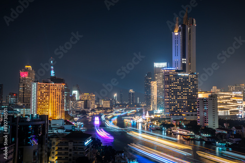 Beautiful modern building with beautiful lighting at night scene show river front living in Bangkok, Thailand photo