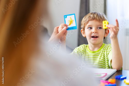 Child learning letters with flashcards photo