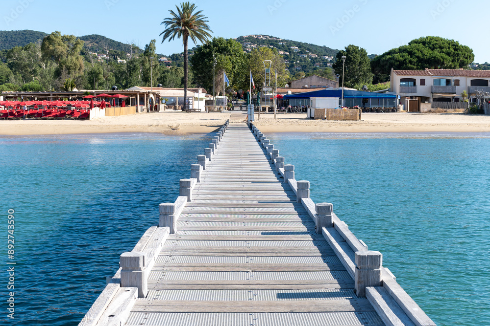Morning view on crystal clear blue water of Plage du Debarquement white sandy beach near Cavalaire-sur-Mer and La Croix-Valmer, summer vacation on French Riviera, Var, France Morning view on crystal clear blue water of Plage du Debarquement white sandy beach near Cavalaire-sur-Mer and La Croix-Valmer, summer vacation on French Riviera, Var, France