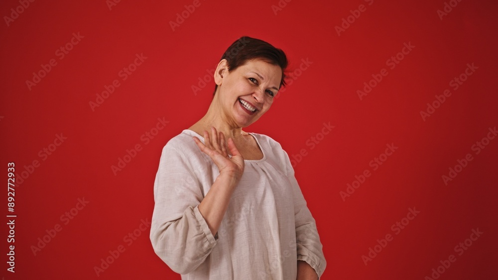 Embarrassed Woman on Red Background Trying to Stay Humble Embarrassed Woman on Red Background Trying to Stay Humble