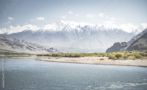 Panoramic landscape in Tien Shan mountains in Pamir with Panj river and mountains in Afghanistan and Tajikistan, sunny morning landscape for background photo