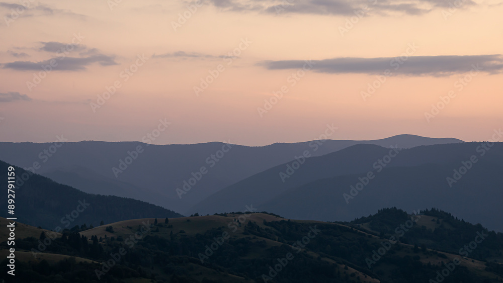 Orange sunset with the setting sun behind the mountains Orange sunset with the setting sun behind the mountains
