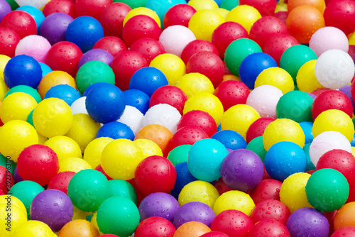 Hundreds of colorful plastic balls on kids playground.