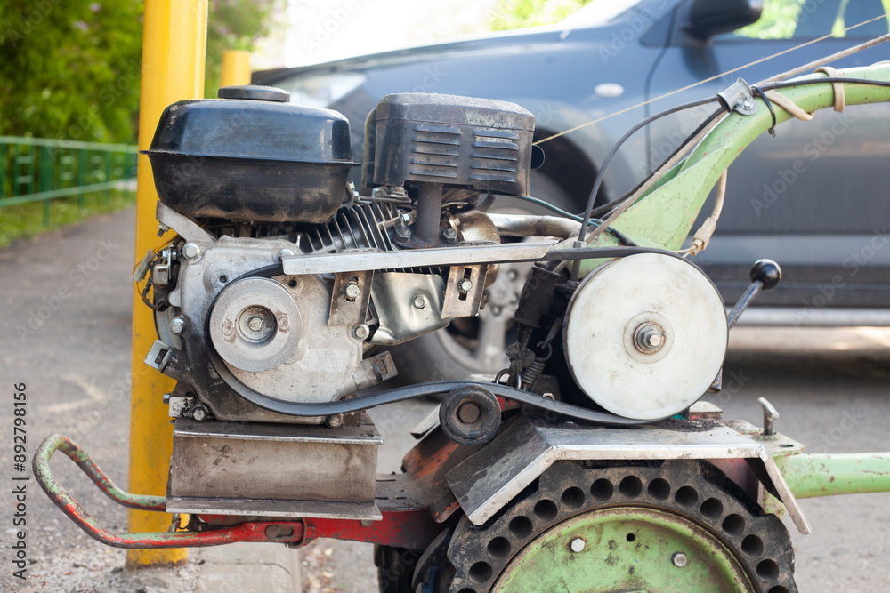 Walk-behind tractor in the parking lot. Ploughing equipment. Diesel Engine on Wheels.