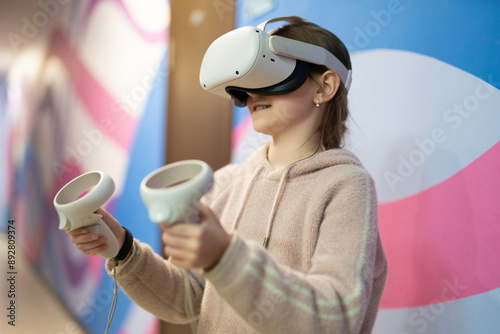 a child in virtual reality glasses plays a game