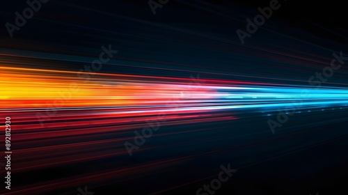 A colorful, blurry image of a train with a red stripe. The train is moving quickly and the colors are vibrant.