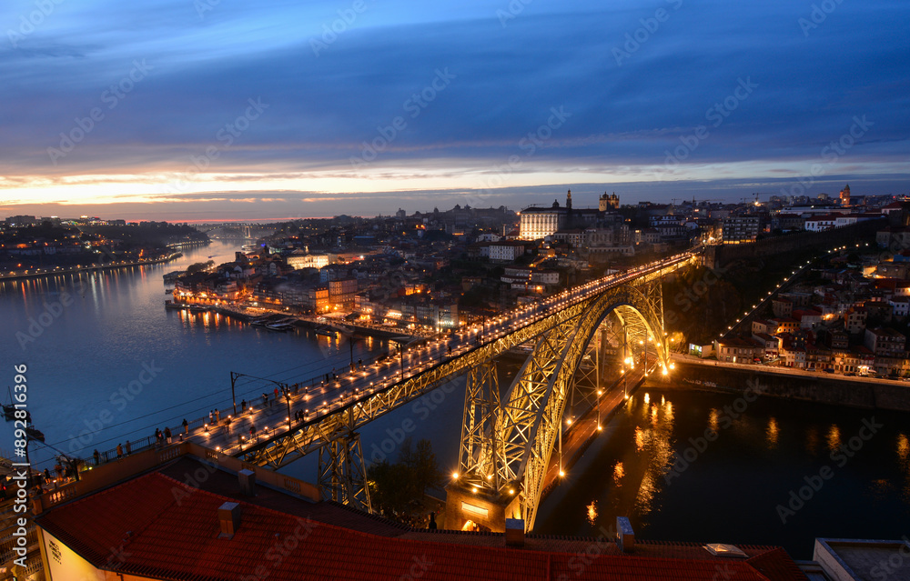 Obraz premium Night skyline of Porto, Portugal, with the Dom Luis I Bridge, a metal arch bridge and symbol of the city, with Douro river and Ribeira district and Porto old town in the background