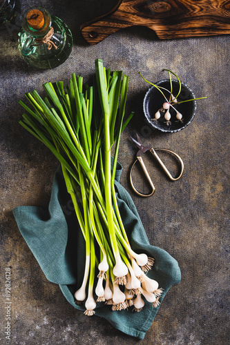 New trendy vegetable sweet garleek on a cloth on the table top and vertical view photo