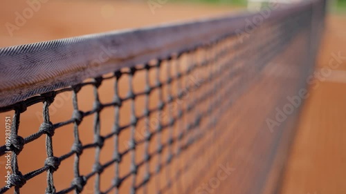 Closeup shot of a clay tennis court net, illustrating sports photography background