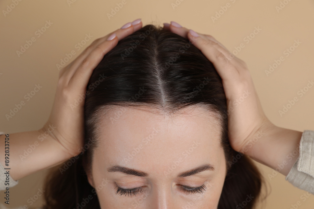 Woman with hair loss problem on beige background, closeup Woman with hair loss problem on beige background, closeup