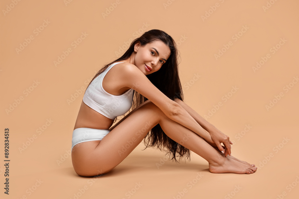 Beautiful woman with perfect skin on beige background. Body care Beautiful woman with perfect skin on beige background. Body care