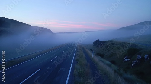 Highway at dawn, empty road, morning mist, serene landscape photo