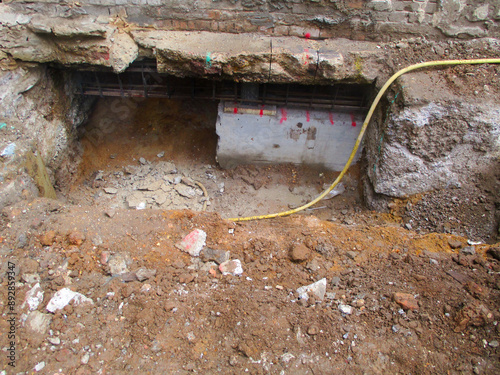 Underpinning process for strengthening and stabilizing the foundation of an existing building. Structural reinforcement and foundation stabilization.
