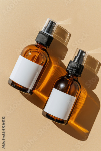 Two Amber Spray Bottles On Beige Background