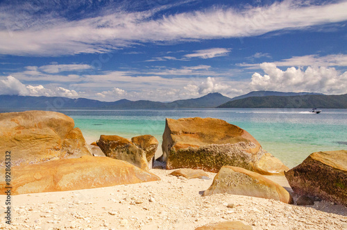 Picturesque tropical beach with boulders and turquoise water on Fitzroy Island. It is a continental island southeast of Cairns, Queensland, Australia. photo