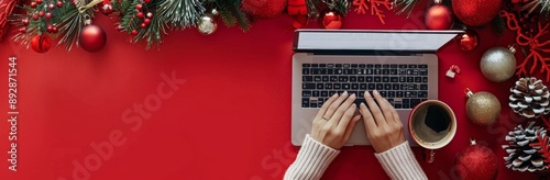 Person Typing on Laptop With Christmas Decorations