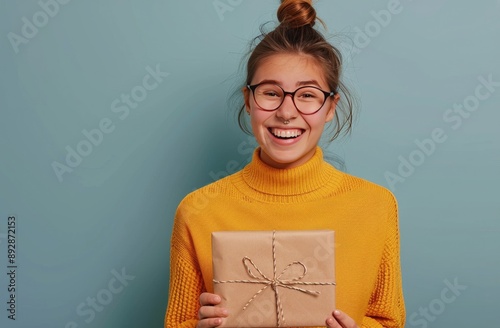Woman Holding Gift, Smiling, Blue Background