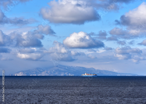 Fototapeta Naklejka Na Ścianę i Meble -  View from cargo ship at sea to dramatic clouds and colorful sunset ahead