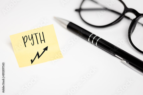 A yellow piece of paper on a white background with a handwritten inscription 