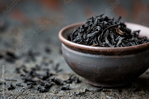 Highquality black tea leaves in rustic bowl, perfect for culinary and beverage backgrounds