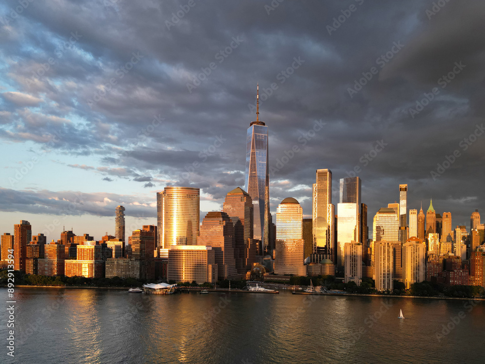 Obraz premium New York City top view. NYC aerial view, New York City Skyline with dramatic sky. Panoramic drone view on Manhattan in NY. Sunset in NYC. New York City Midtown skyline view at dusk with clouds.