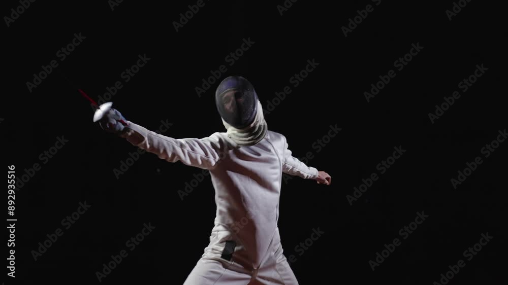 Fencer Fencing Alone, Training, Fighting With Imaginary Rival, Slow Motion Portrait In Fencing Track Fencer Fencing Alone, Training, Fighting With Imaginary Rival, Slow Motion Portrait In Fencing Track