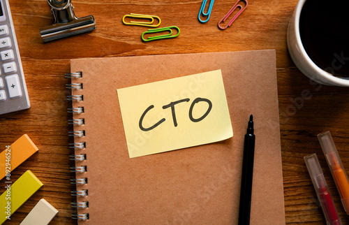 There is sticky note with the word CTO. It is an abbreviation for Chief Technology Officer as eye-catching image.