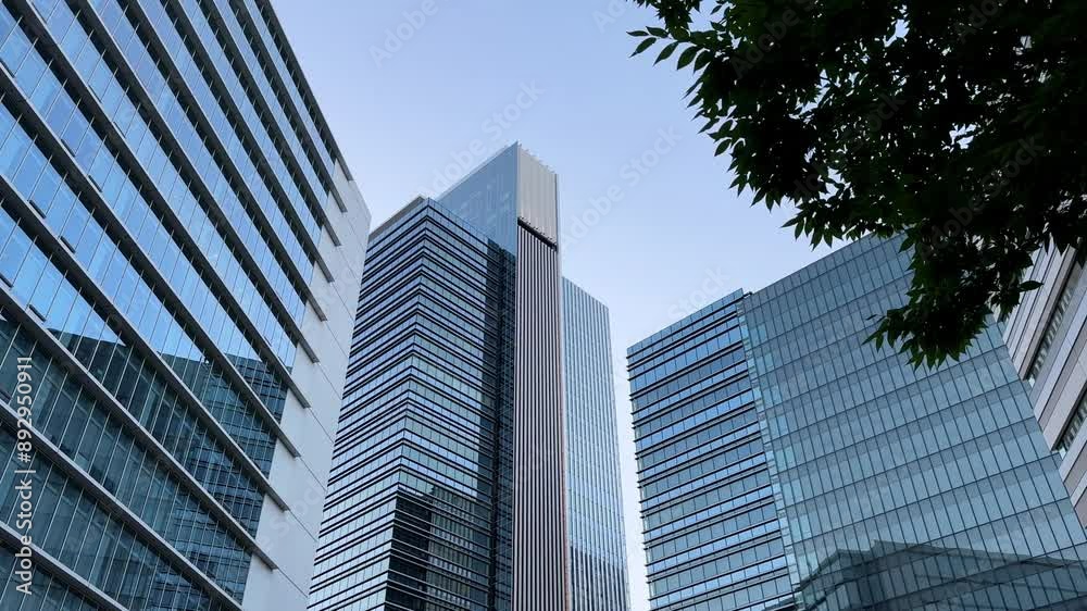 Tall modern office buildings against a clear sky, viewed from below Tall modern office buildings against a clear sky, viewed from below