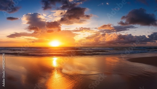 beautiful sunset on ocean beach sky is reflecting at water amazing colorful sunrise at sea © Lauren