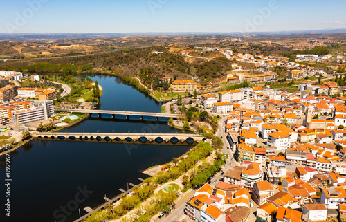 Drone photo of Mirandela, Portugal. View of buildings along Tua embankment and bridges. photo