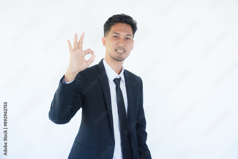 Asian businessman smiling confident and giving OK sign