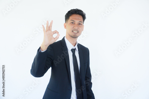 Asian businessman smiling confident and giving OK sign