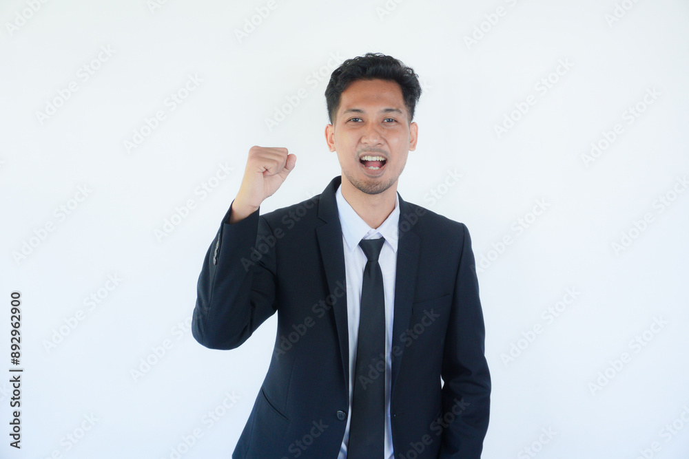 Asian businessman clenched fist showing optimist expression Asian businessman clenched fist showing optimist expression