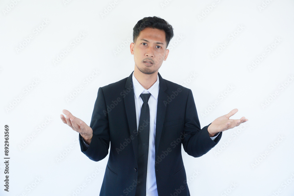 Adult Asian man wearing black suit and tie showing confused gesture Adult Asian man wearing black suit and tie showing confused gesture