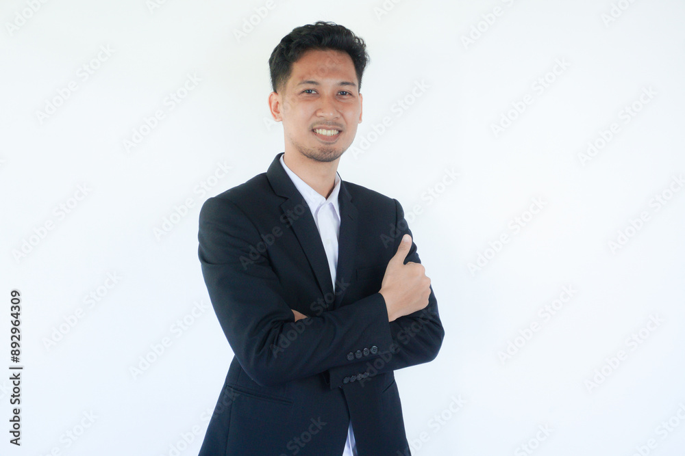 Asian businessman smiling confident and give thumb up with arms crossed Asian businessman smiling confident and give thumb up with arms crossed