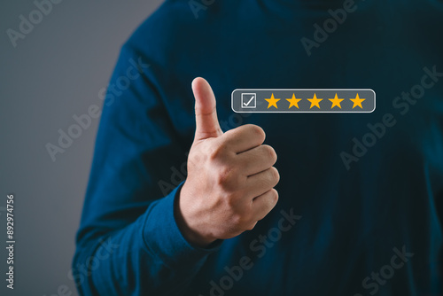 Wall Mural Close-up of a hand showing a thumbs-up gesture with a five-star rating overlay, signifying positive feedback and excellent customer satisfaction
