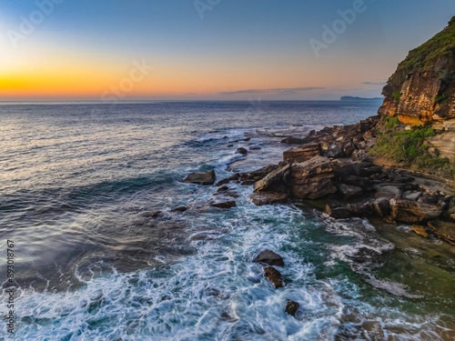 Sunrise seascape with clear skies and orange horizon