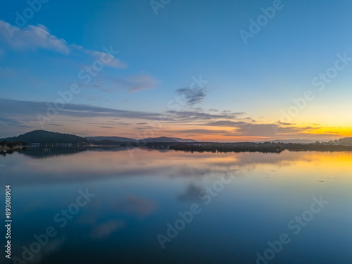 Sunrise along the waterfront with reflections on the bay water