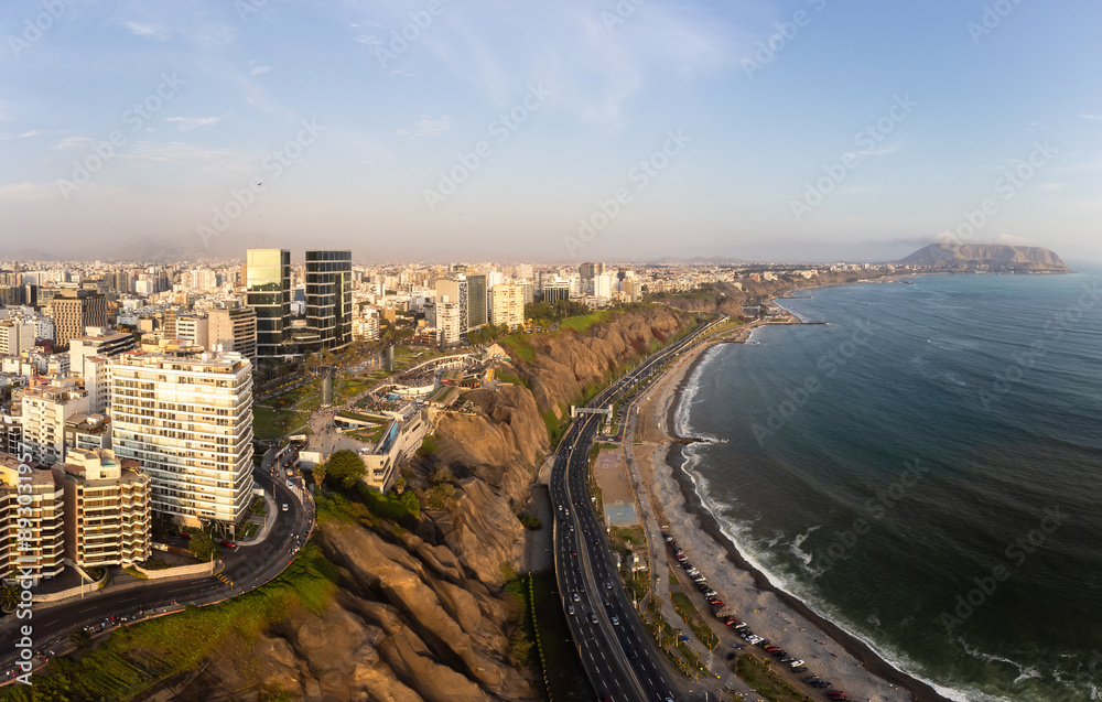 Fototapeta premium Lima, Peru: Aerial drone panorama of the famous Miraflores district above the Coasta Verde coast and highway and the Pacific ocean in Lima, Peru capital.